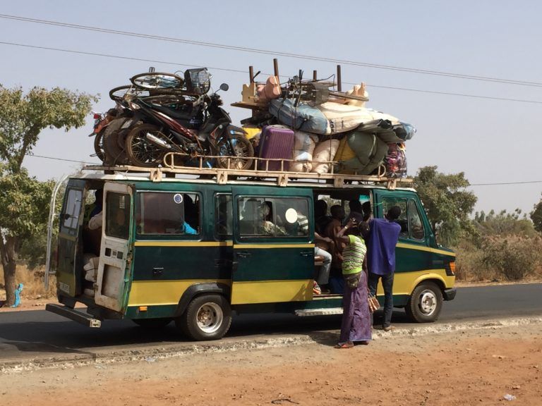 Loading a bus in Burkina Faso. Bus travel in Burkina Faso.