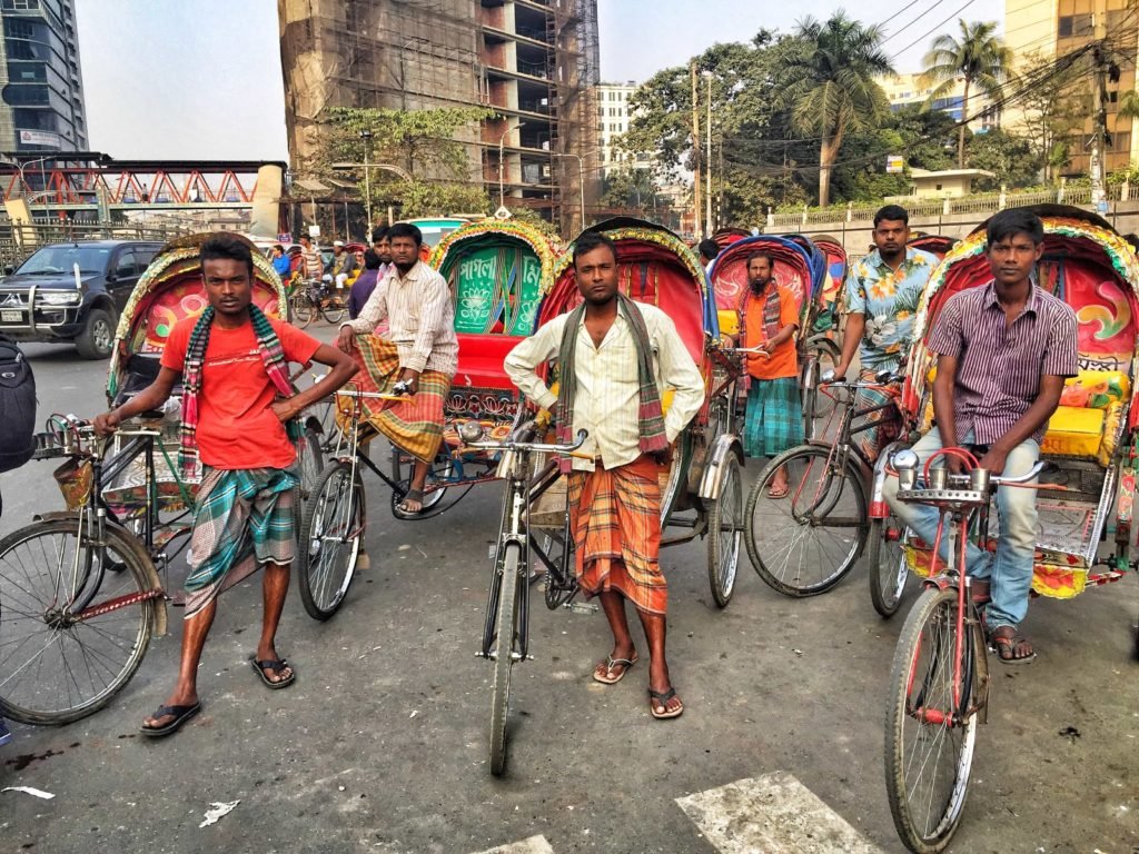 Cycle rickshaw drivers, Dhaka, Bangladesh. You haven't lived til you've zipped around Dhaka in one. There is a veritable fleet of them on every corner.