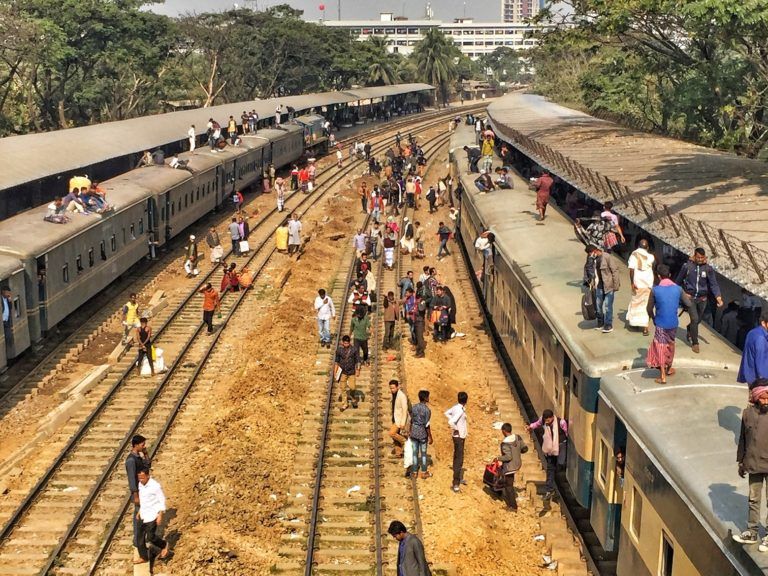Train travel in Bangladesh. There's space for everyone...on the roof. Biman Bandar station, Dhaka, Bangladesh