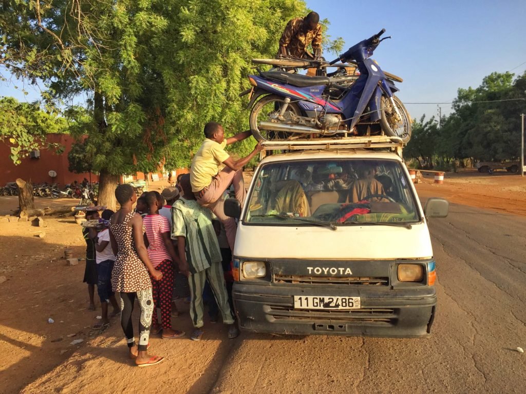 Loading a bus in Burkina Faso. Bus travel in Burkina Faso.
