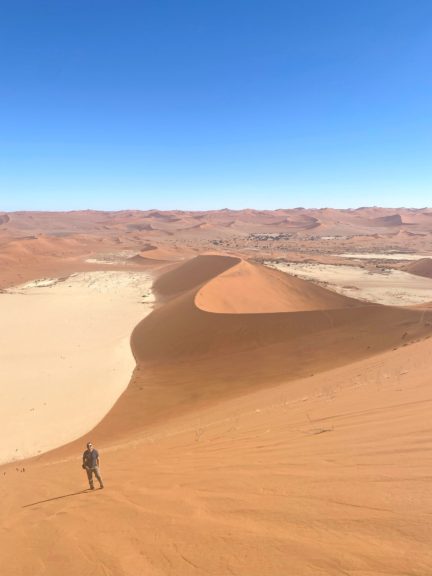 Climbing up the towering sand dunes at Sossusvlei, Namibia