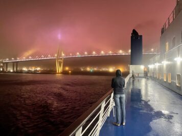 Despite the wind, we stayed out on deck to watch the city lights float by