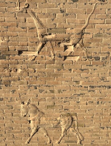 Reliefs imprinted on the walls. Originals are visible near the foundations in some places