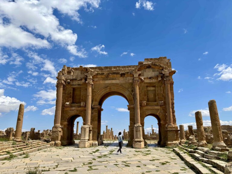 The massive arched gate at Timgad